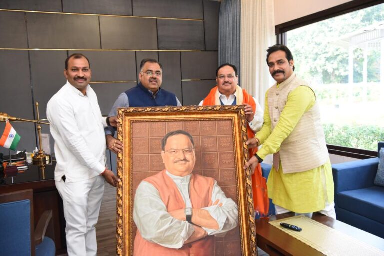 Tarun chugh with Nadda ji presenting birthday gift frame